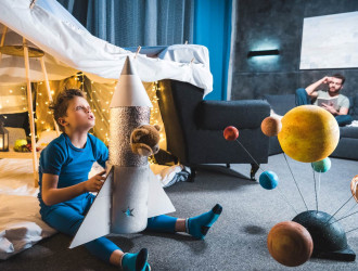 boy sitting in blanket fort with toy rocket and so 2024 11 18 13 25 04 utc