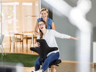 playful employee pushing colleague on office chair 2024 09 17 23 32 05 utc