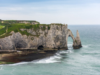 the beach and stone cliffs in etretat france 2024 12 16 06 47 49 utc