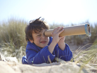 young boy on beach looking through pretend telesc 2023 11 27 05 27 34 utc 1