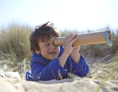 young boy on beach looking through pretend telesc 2023 11 27 05 27 34 utc 1